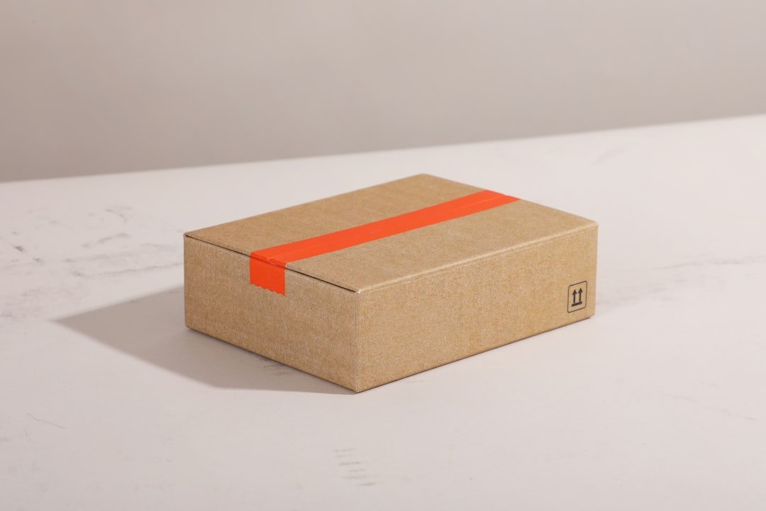 Brown cardboard box with bright orange tape